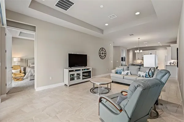 a spacious bedroom with a bed and a large window