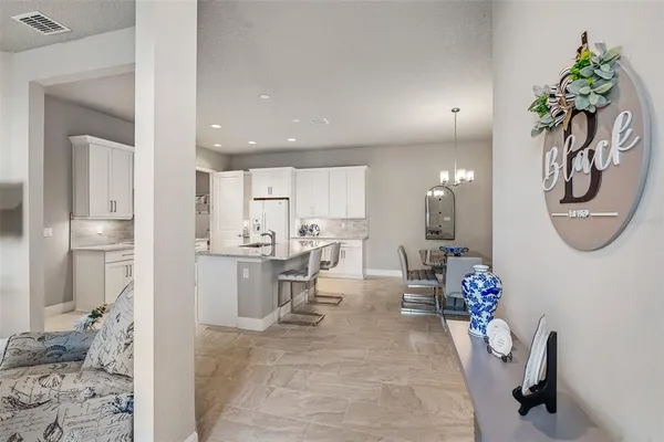 a kitchen with refrigerator and cabinets