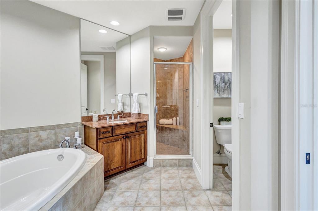 140 Riviera Dunes Way, Unit 206 Palmetto, FL 34221 - Photo 16 of 46 a spacious bathroom with a tub sink and mirror