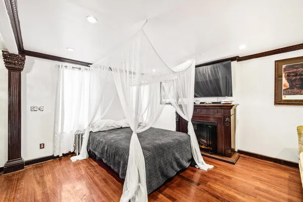 a bedroom with a bed and a fireplace