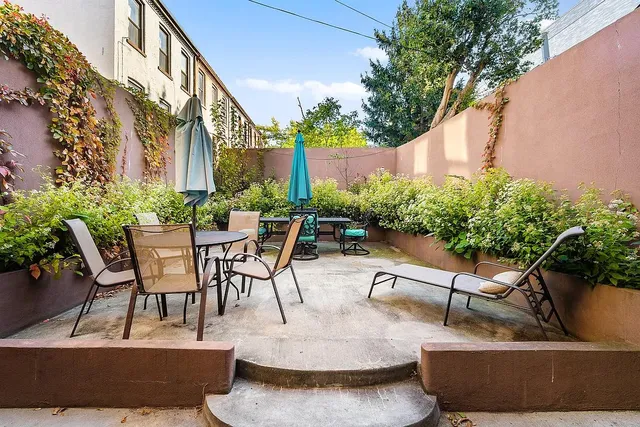 a view of a patio with table and chairs and potted plants