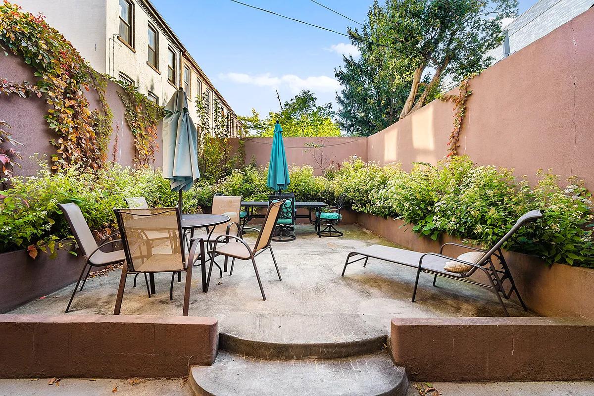 147 Patchen Avenue, Unit GARDEN Brooklyn, NY 11221 - Photo 6 of 7 a view of a patio with table and chairs and potted plants