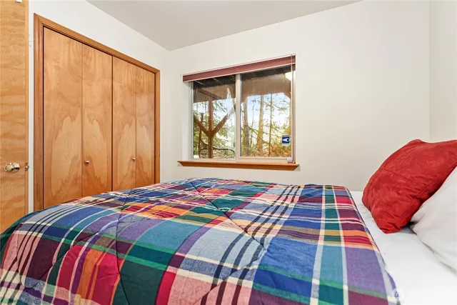 a bedroom with a bed and a window