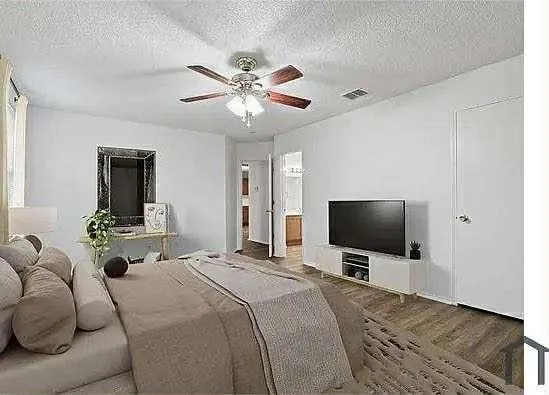 a bedroom with a bed and a flat screen tv