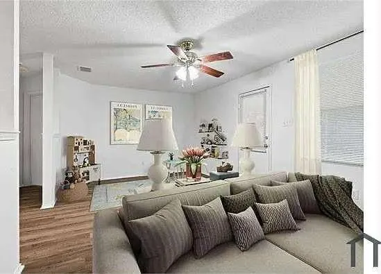 a living room with furniture and a large window