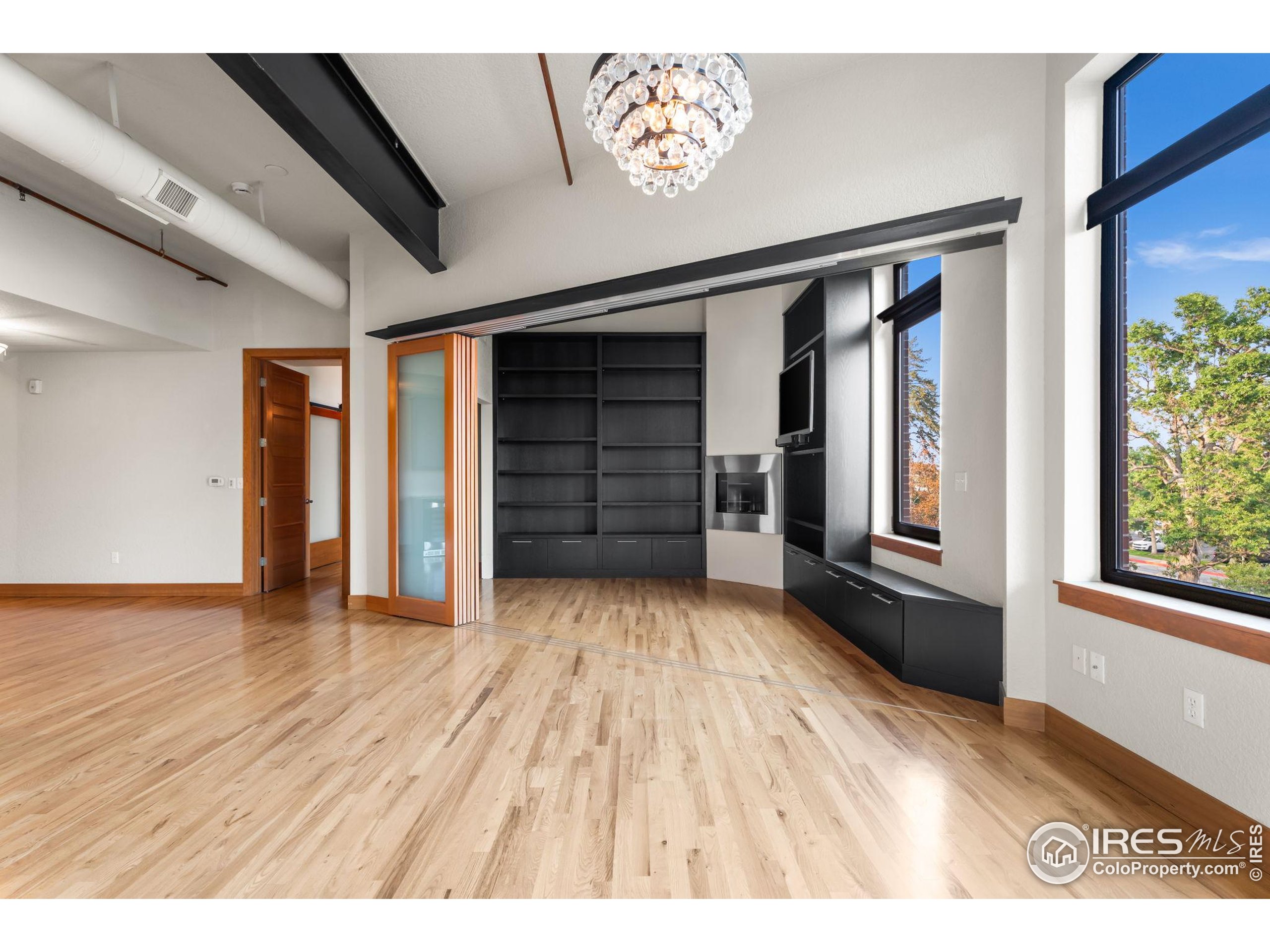 210 West Magnolia Street, Unit 320 Fort Collins, CO 80521 - Photo 19 of 45 wooden floor in an empty room with a window