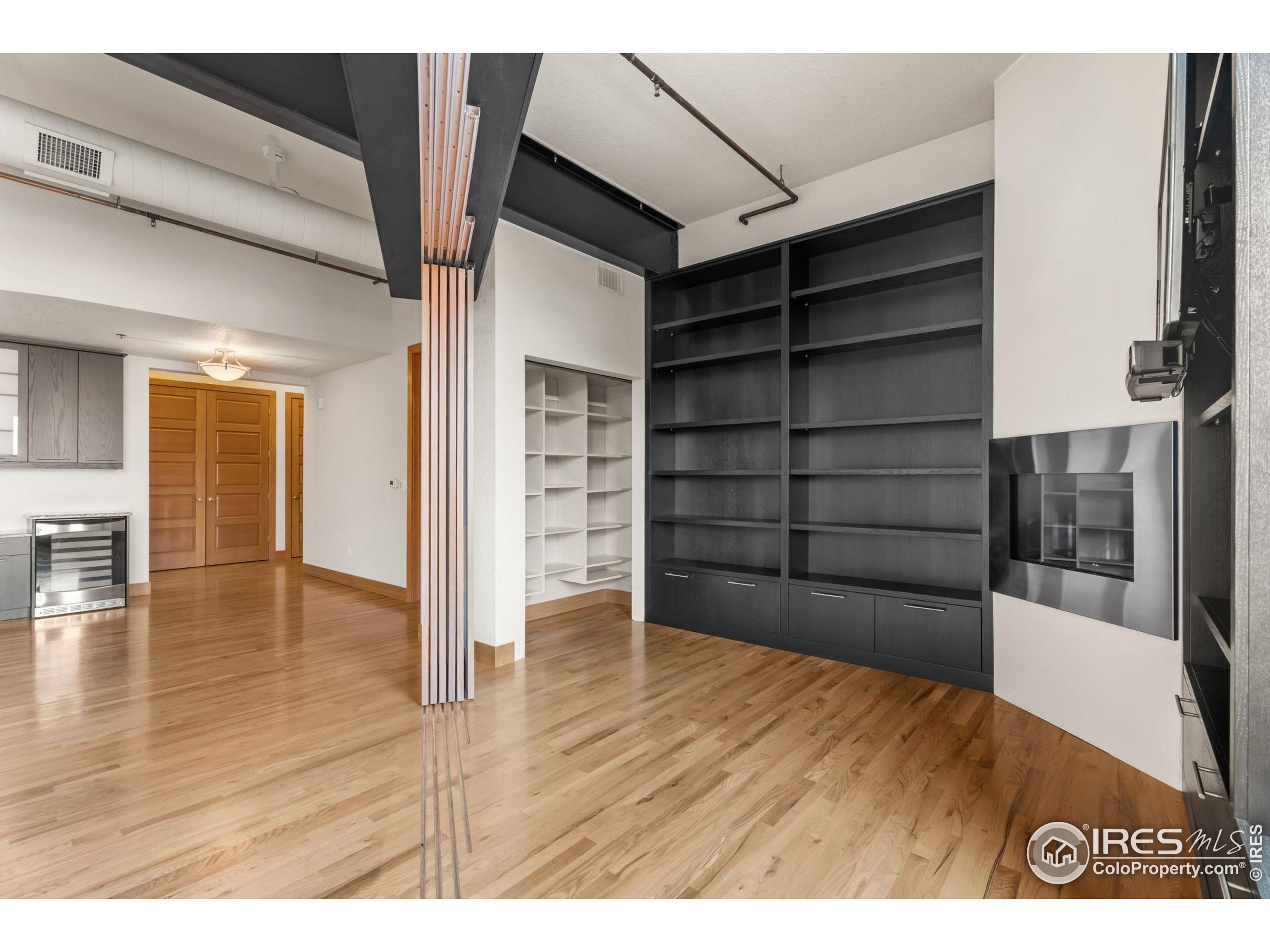 210 West Magnolia Street, Unit 320 Fort Collins, CO 80521 - Photo 21 of 45 a view of wooden floor and windows in a room