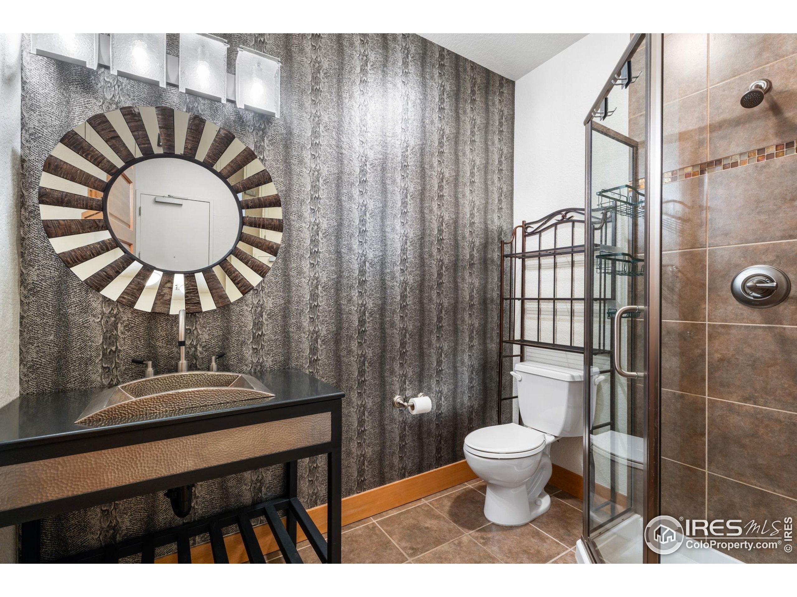 210 West Magnolia Street, Unit 320 Fort Collins, CO 80521 - Photo 25 of 45 a bathroom with a toilet a sink and a mirror