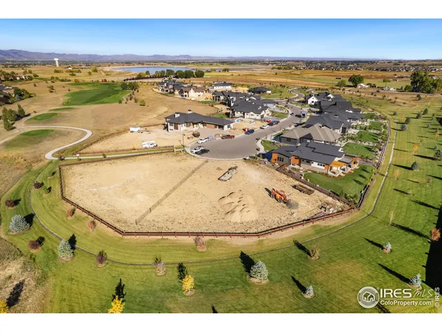an aerial view of a swimming pool with a yard