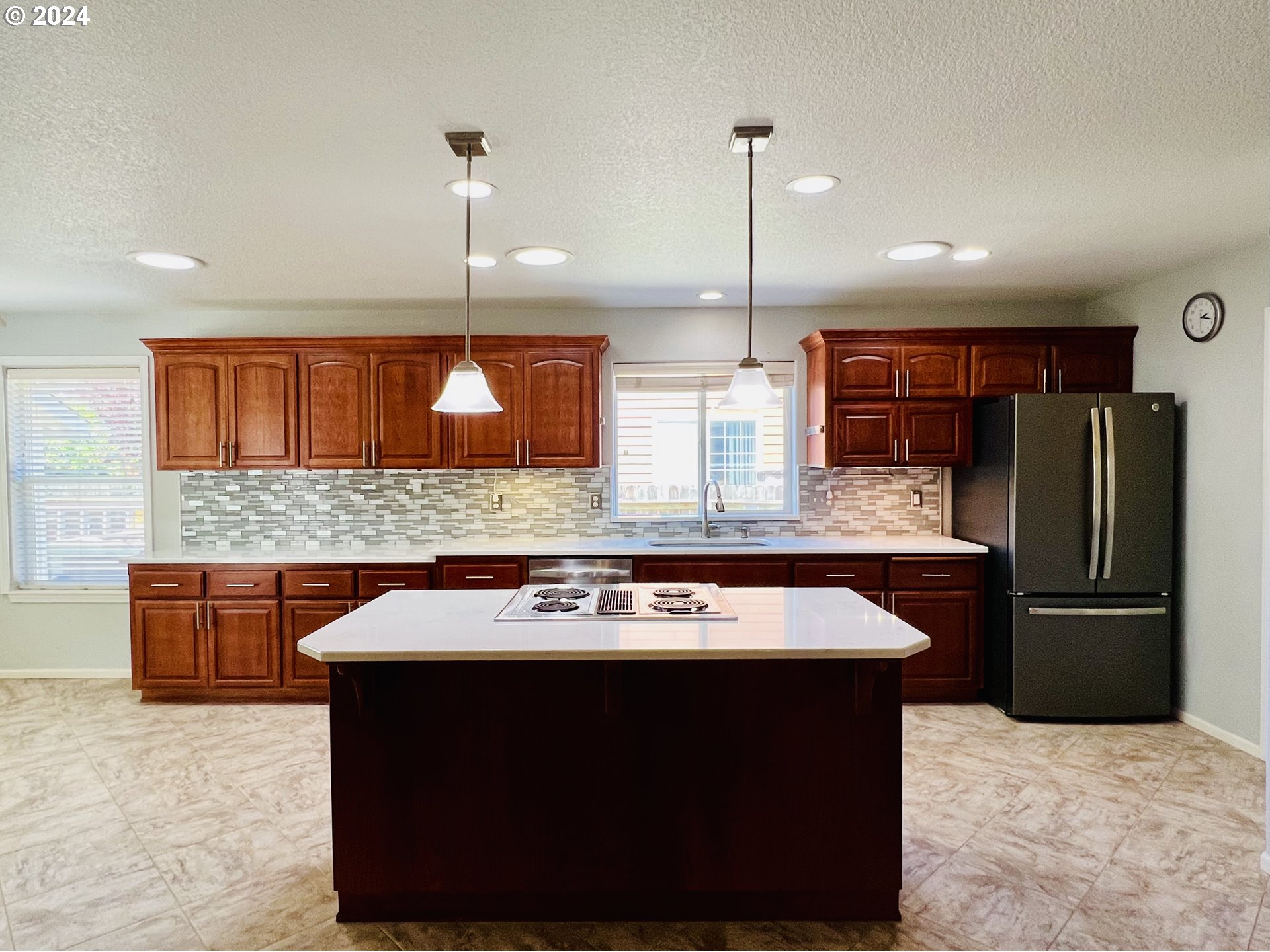 307 Ridgeway Street Sutherlin, OR 97479 - Photo 12 of 40 a kitchen with stainless steel appliances granite countertop a sink a stove a refrigerator and wooden cabinets