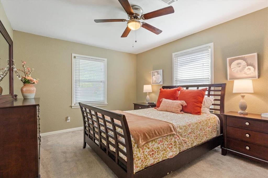 2209 North 52nd Street Waco, TX 76710 - Photo 19 of 34 a bedroom with a bed and a chandelier
