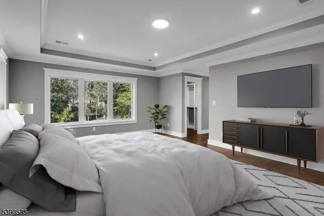 a bedroom with a bed and a flat screen television