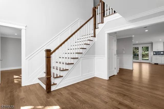 a view of entryway with wooden floor and stairs