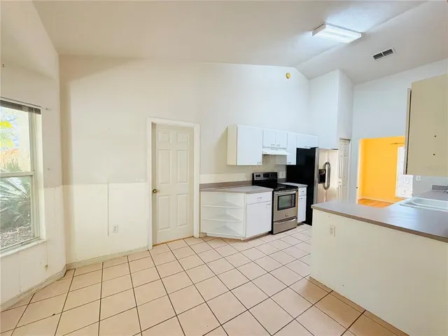 a kitchen with granite countertop a sink and a stove top oven