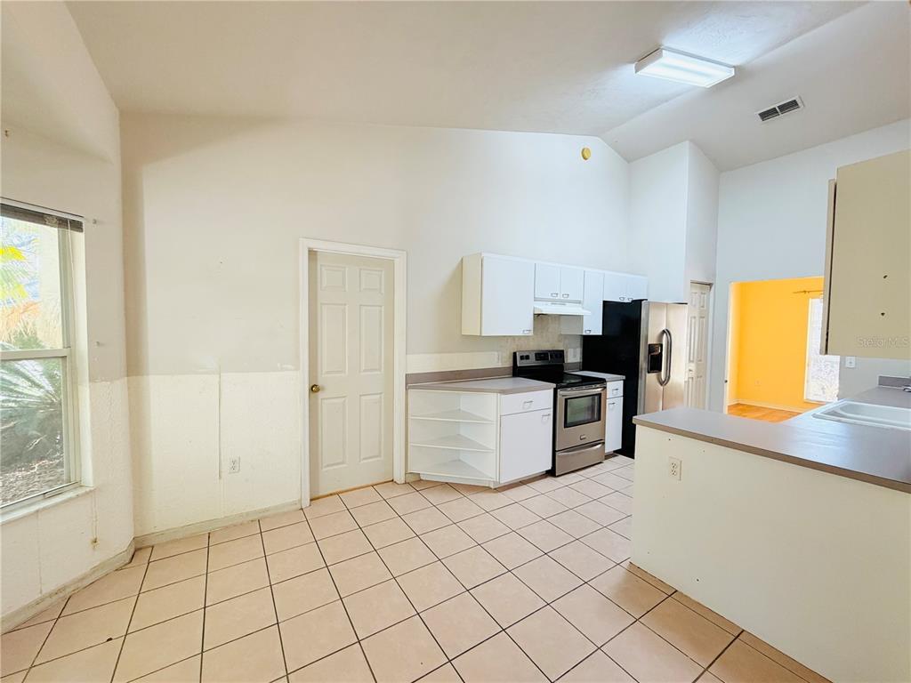 4423 Northwest 36th Street Gainesville, FL 32605 - Photo 19 of 43 a kitchen with granite countertop a sink and a stove top oven