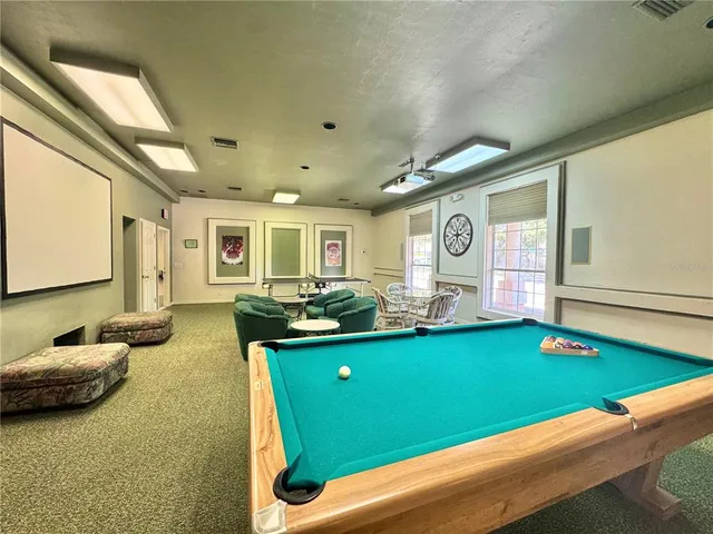 a living room with kitchen island furniture and a swimming pool