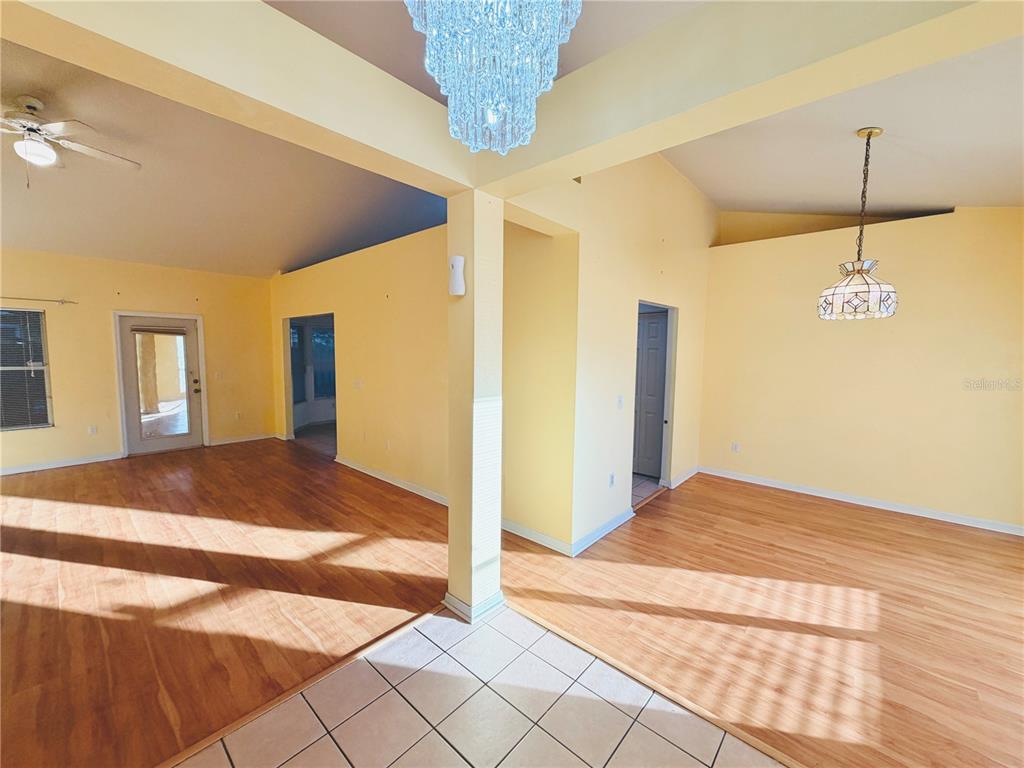 4423 Northwest 36th Street Gainesville, FL 32605 - Photo 7 of 43 a spacious bedroom with a bed and a chandelier