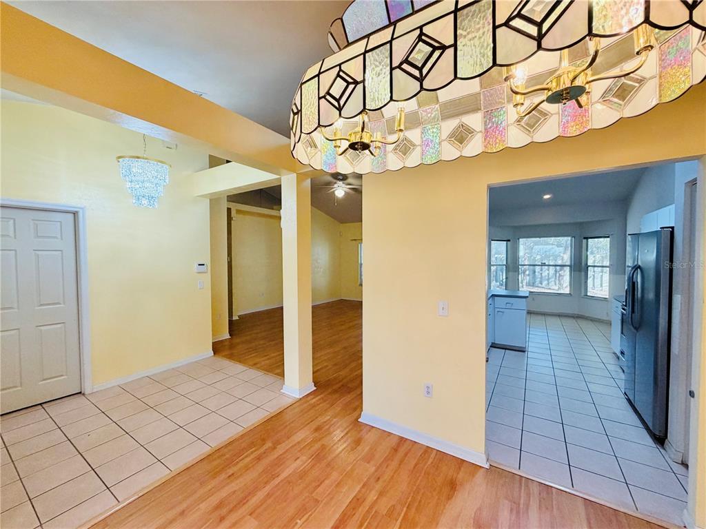 4423 Northwest 36th Street Gainesville, FL 32605 - Photo 8 of 43 a view of a hallway with wooden floor and a glass door