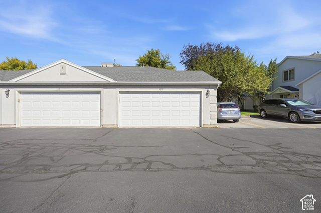 108 Penhurst Place Logan, UT 84341 - Photo 37 of 44 Two-car garage with white paneled doors and stucco exterior
