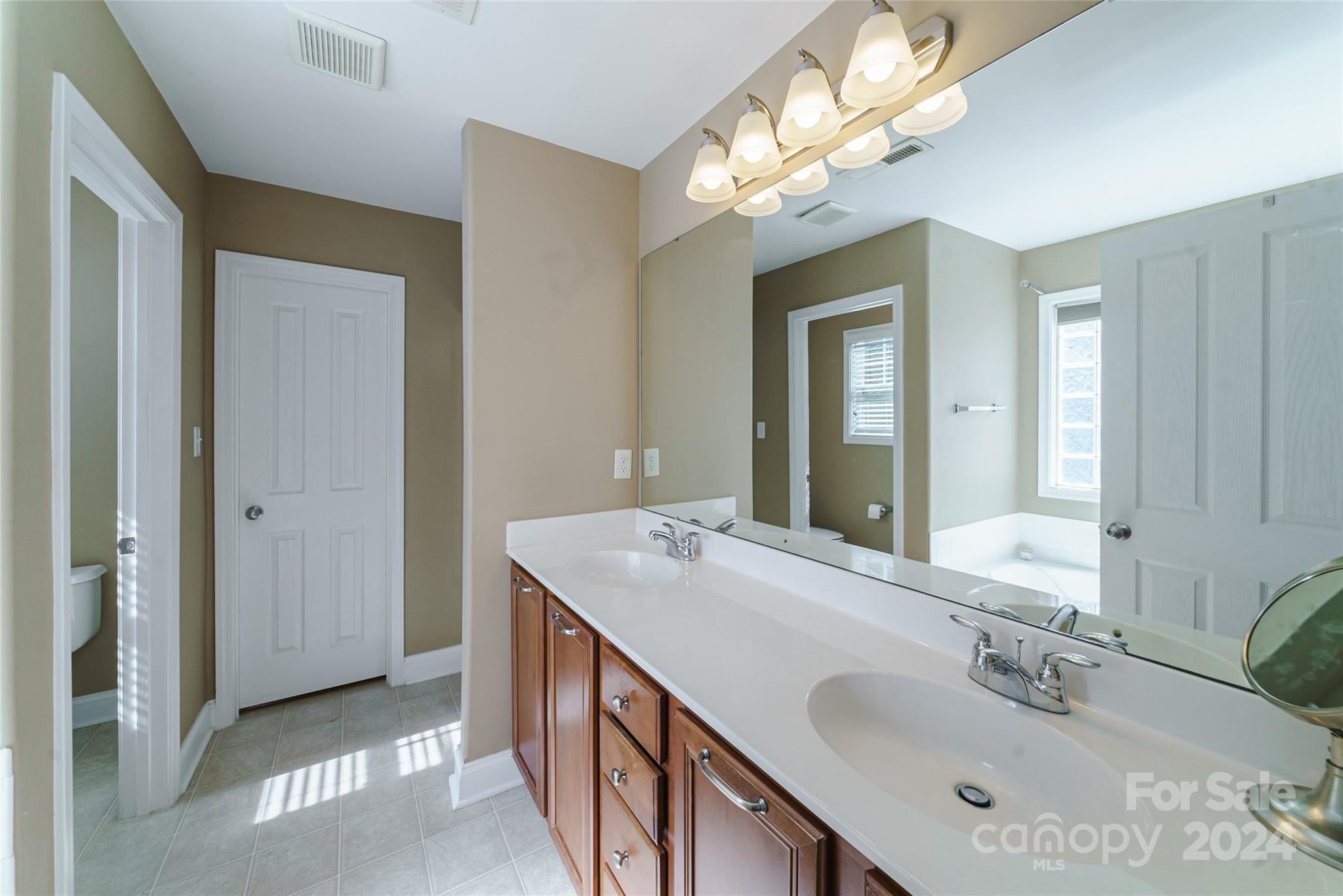 9917 Shellview Lane Charlotte, NC 28214 - Photo 19 of 35 a bathroom with a sink double vanity and a mirror