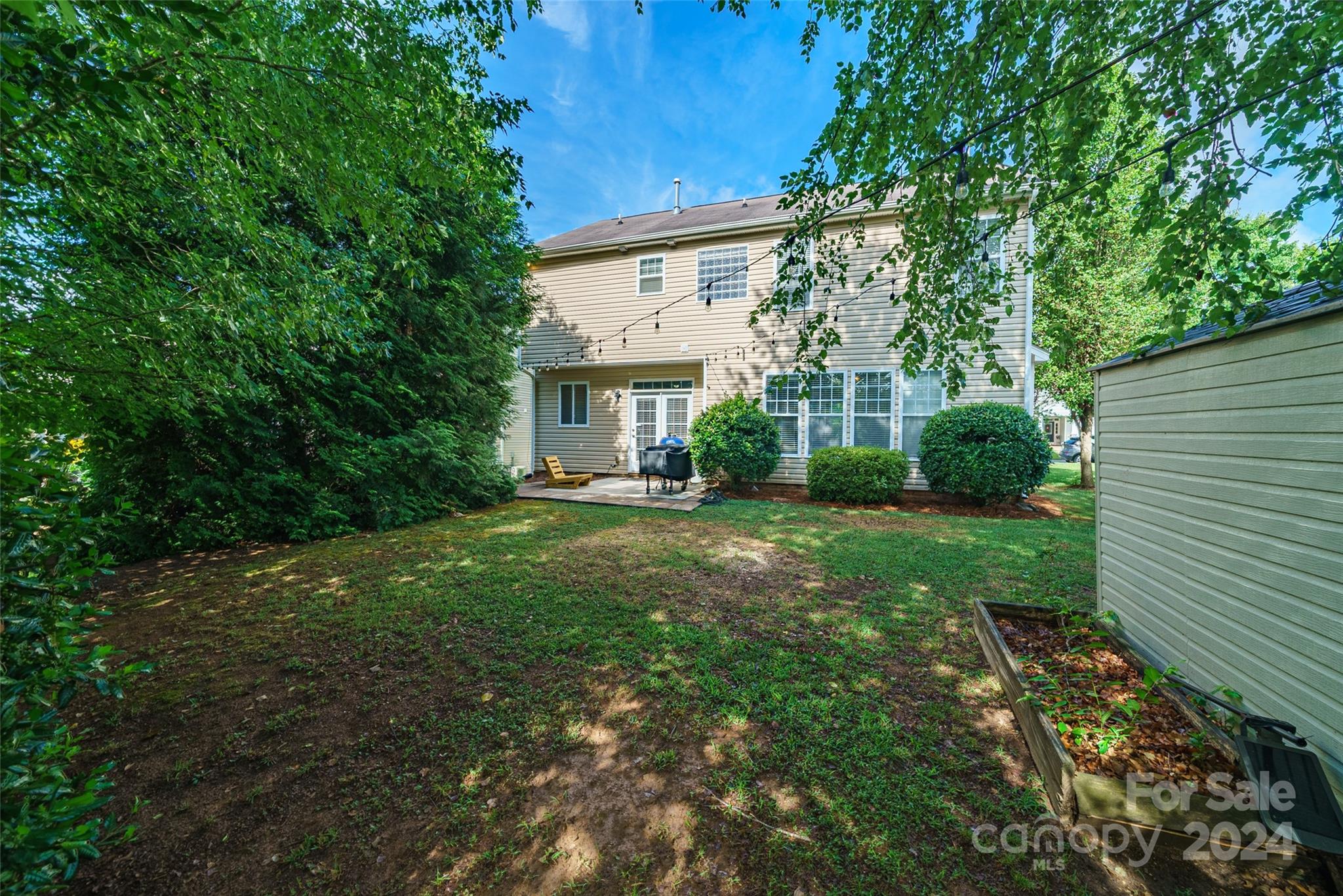 9917 Shellview Lane Charlotte, NC 28214 - Photo 29 of 35 a view of house in front of a yard with potted plants and large trees