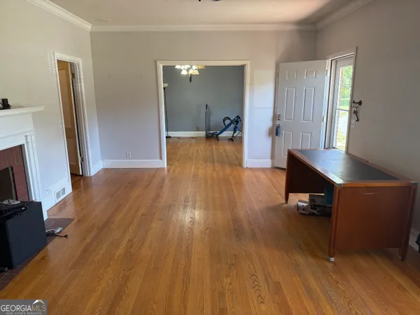 a view of a room with wooden floor and staircase