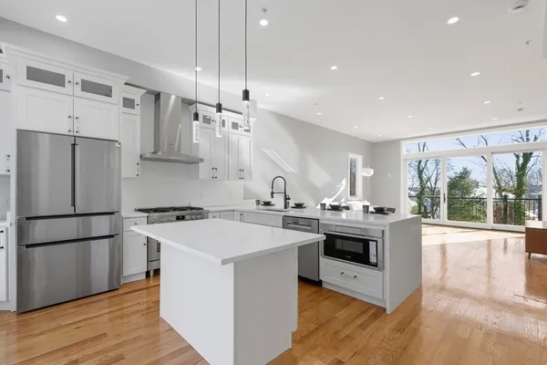 a kitchen with stainless steel appliances a stove a sink and a refrigerator