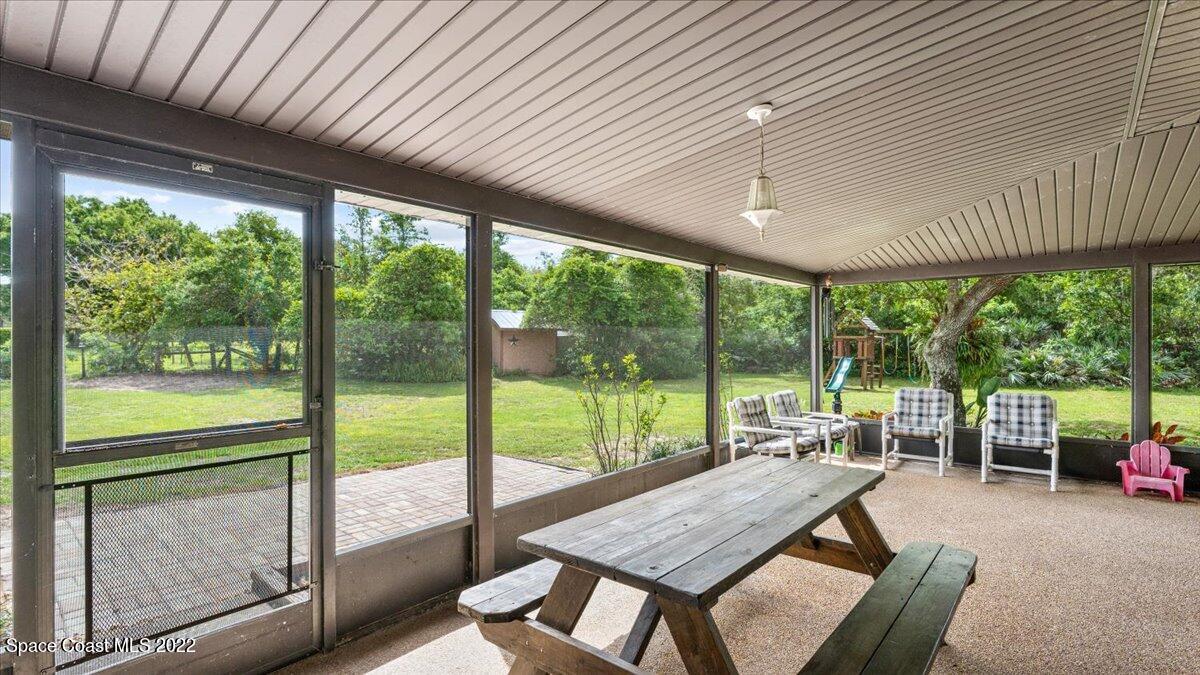 3655 Grant Line Road Mims, FL 32754 - Photo 17 of 47 a view of a patio with a table chairs and a table