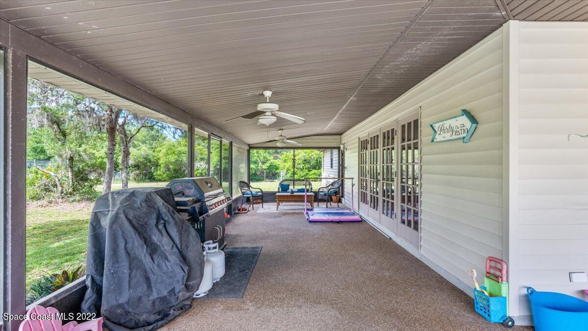 3655 Grant Line Road Mims, FL 32754 - Photo 19 of 47 a view of a porch with furniture and garden
