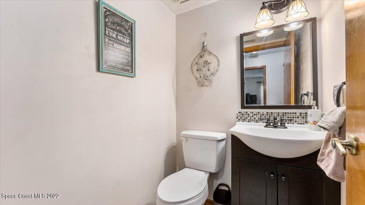 3655 Grant Line Road Mims, FL 32754 - Photo 24 of 47 a bathroom with a toilet sink and mirror