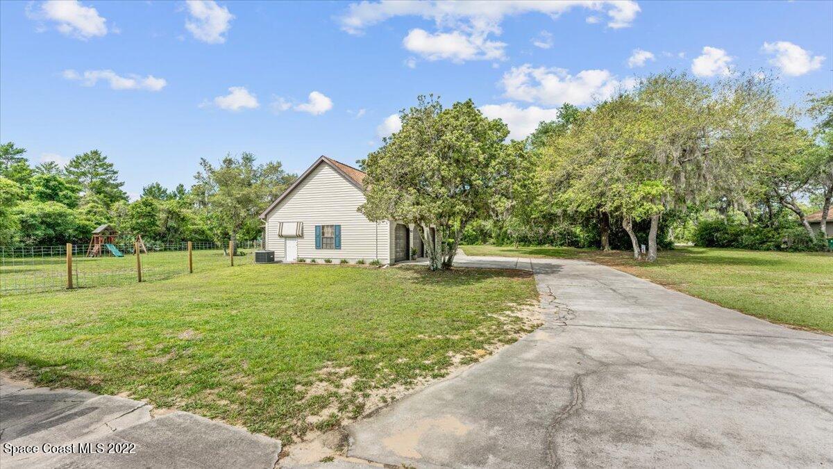 3655 Grant Line Road Mims, FL 32754 - Photo 32 of 47 a view of a house with backyard and trees
