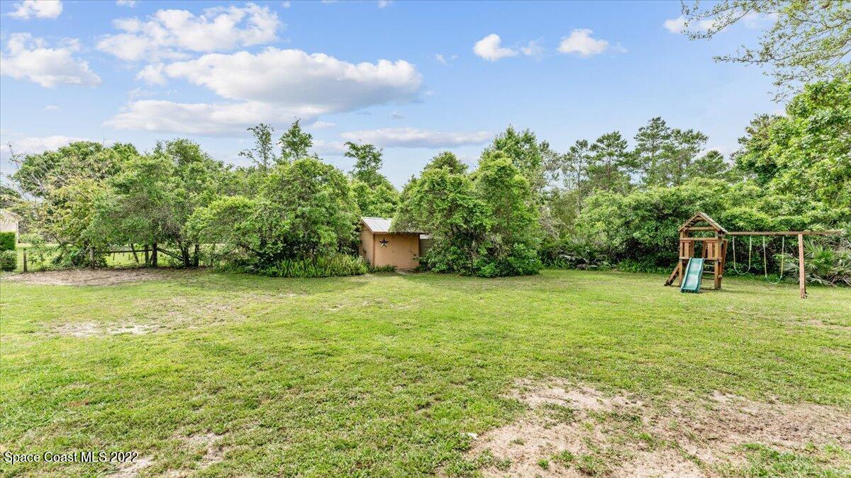 3655 Grant Line Road Mims, FL 32754 - Photo 33 of 47 a backyard of a house with lots of green space