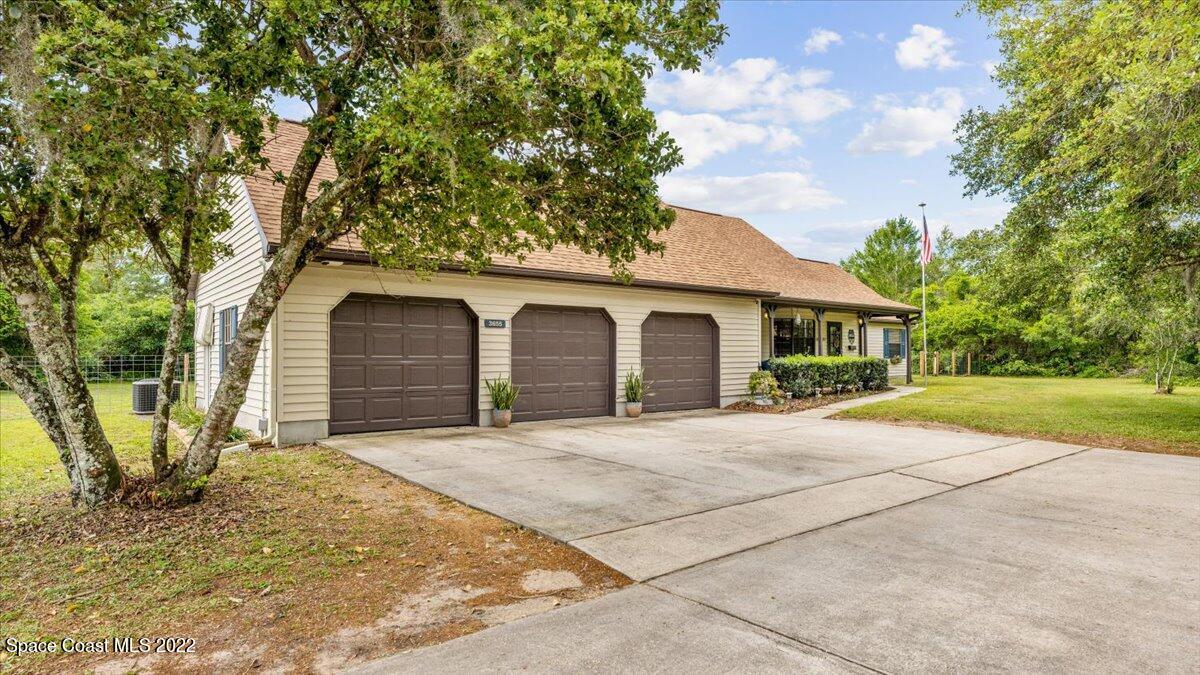 3655 Grant Line Road Mims, FL 32754 - Photo 3 of 47 a front view of a house with garden