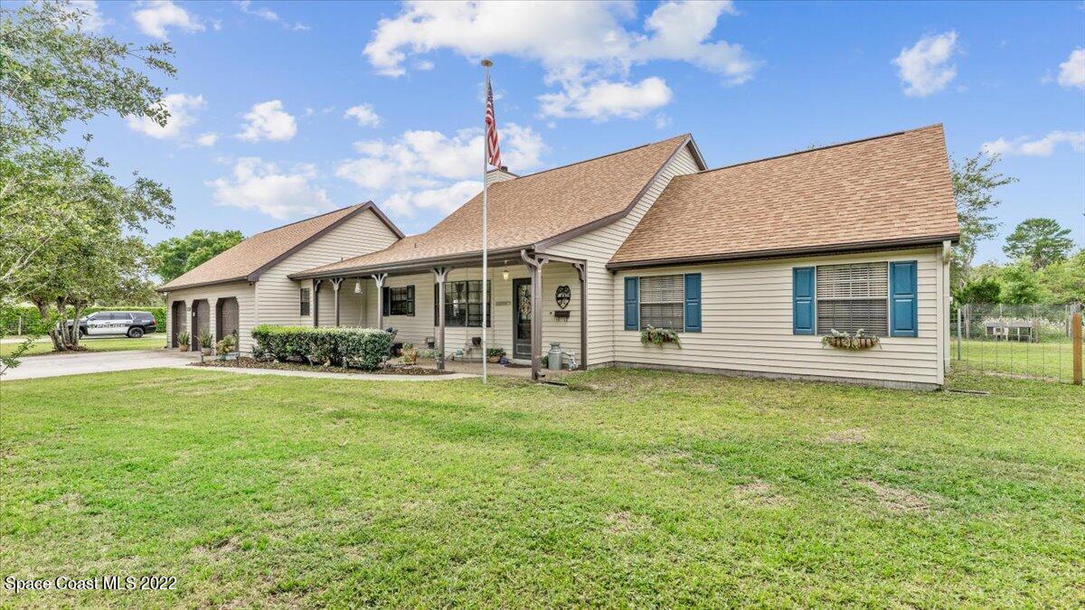3655 Grant Line Road Mims, FL 32754 - Photo 4 of 47 a front view of a house with a garden