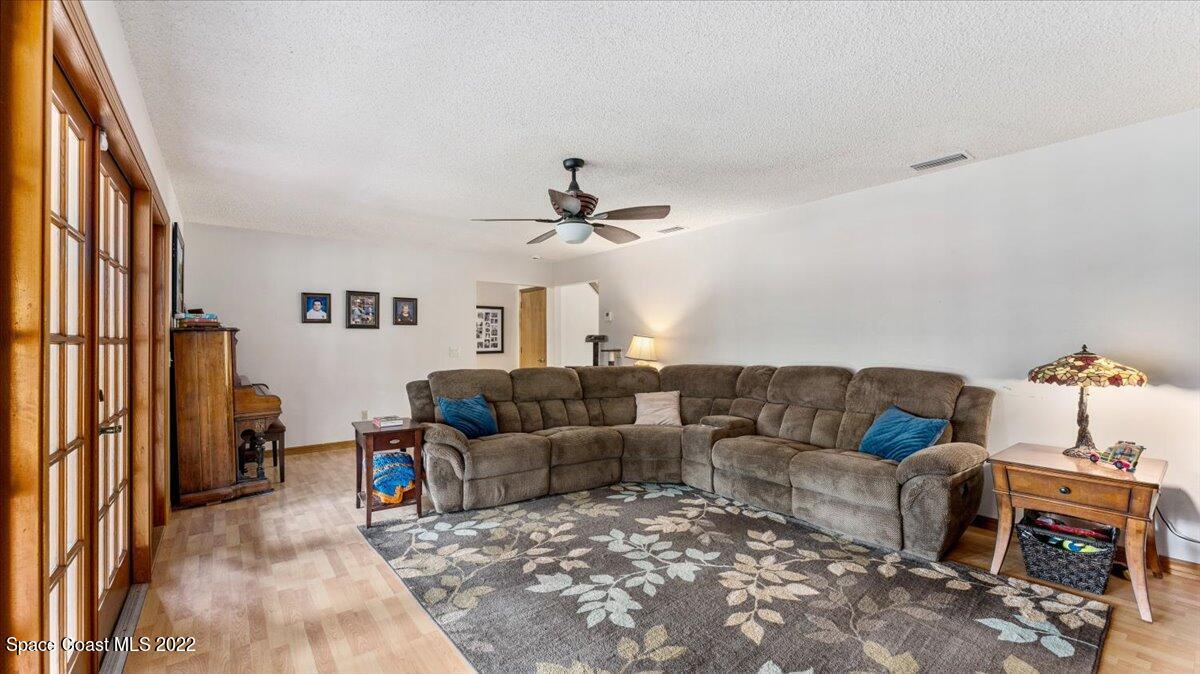 3655 Grant Line Road Mims, FL 32754 - Photo 7 of 47 a living room with furniture and a window