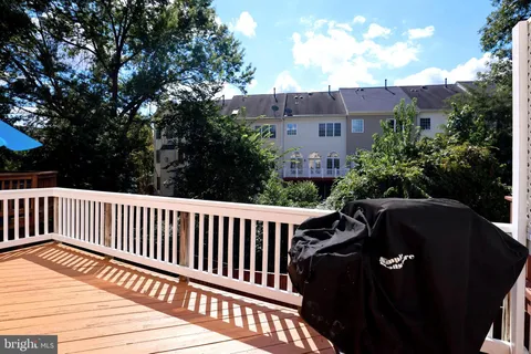 a bedroom with a balcony a bed and a flat screen television