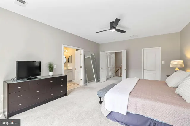 a bedroom with a bed and a night stand