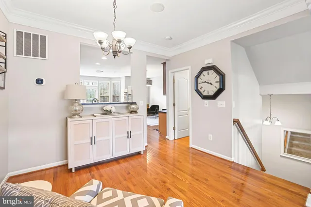 a living room with furniture a large window and a chandelier