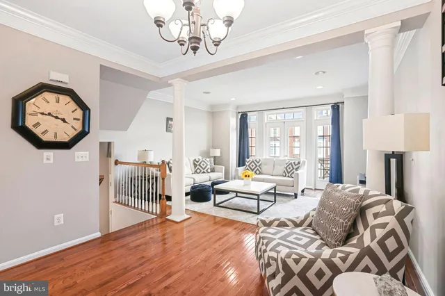 a kitchen with stainless steel appliances a dining table chairs refrigerator and sink