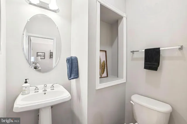 a kitchen with stainless steel appliances granite countertop a table chairs refrigerator and wooden cabinets