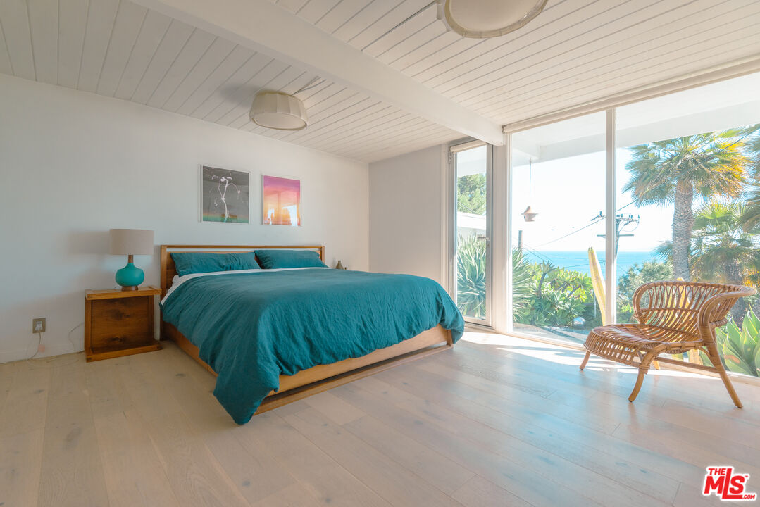 20647 Seaboard Road Malibu, CA 90265 - Photo 16 of 35 a spacious bedroom with a bed and large windows