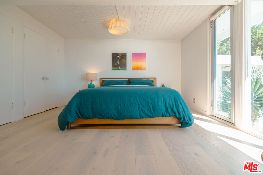 20647 Seaboard Road Malibu, CA 90265 - Photo 17 of 35 a bedroom with a bed and a window