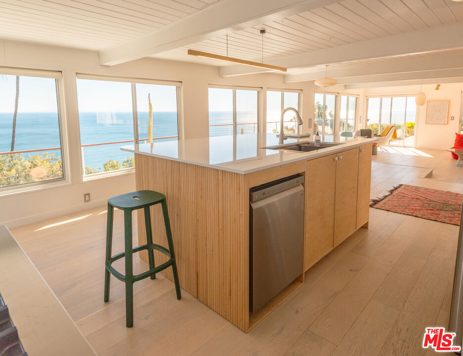 20647 Seaboard Road Malibu, CA 90265 - Photo 23 of 35 a kitchen with a sink and large windows