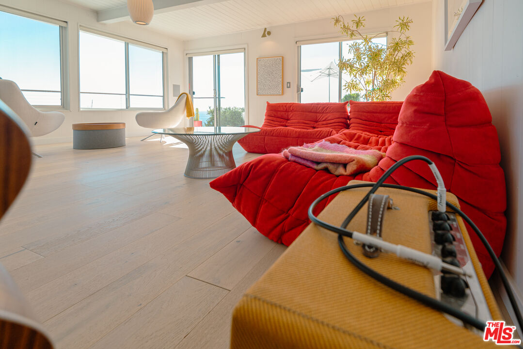 20647 Seaboard Road Malibu, CA 90265 - Photo 28 of 35 a living room with furniture and a floor to ceiling window