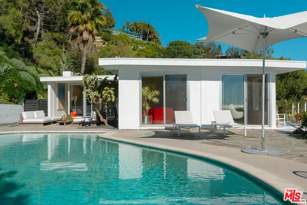 a view of a swimming pool with a yard