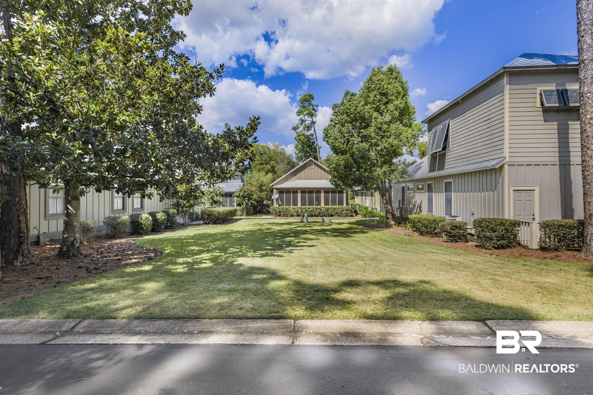 25773 Canal Road Orange Beach, AL 36561 - Photo 1 of 32 View of green lawn