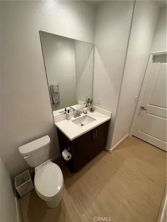 a bathroom with a sink a toilet a mirror and vanity