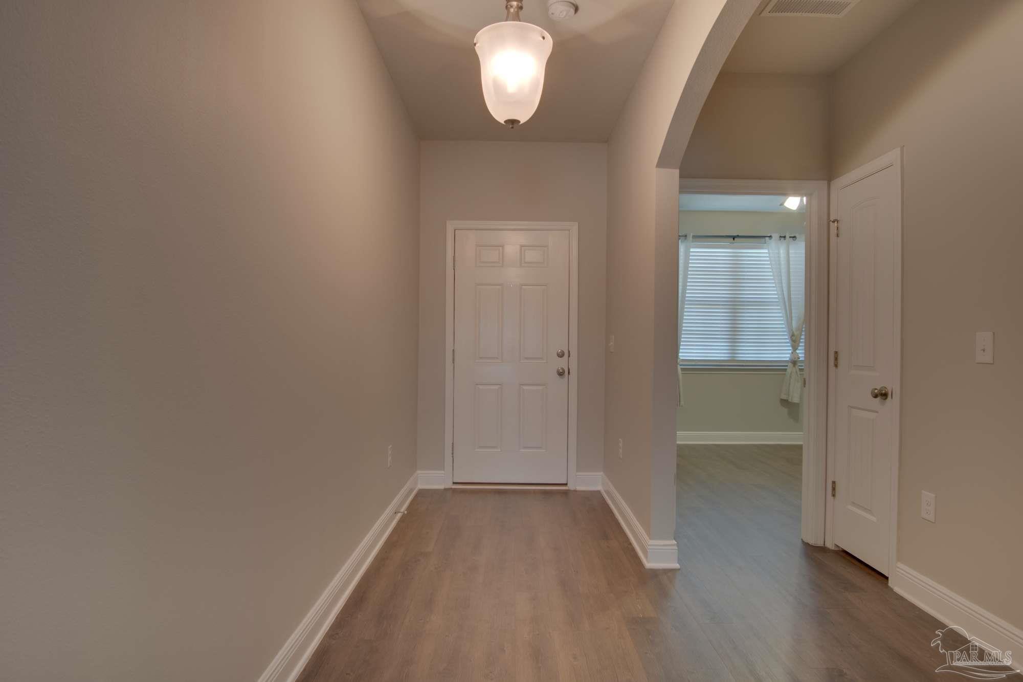 6239 Ladera Trail Pace, FL 32571 - Photo 5 of 27 wooden floor in an empty room with a window