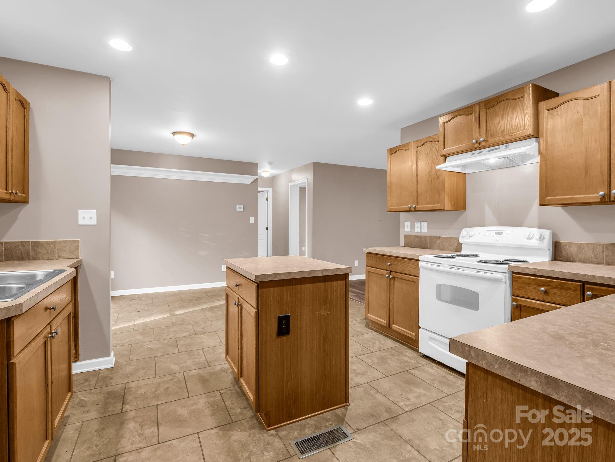 663 Landrum Road Columbus, NC 28722 - Photo 11 of 40 a kitchen with a stove top oven sink and cabinets