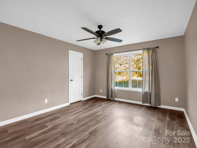 a view of a livingroom with a ceiling fan and window